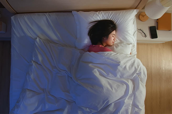 ベッドで眠っている女性